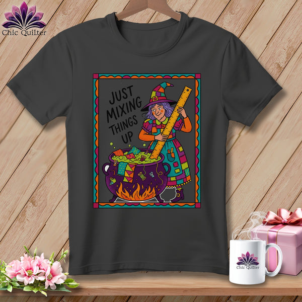 Graphic t-shirt with witch mixing cauldron and text "Just Mixing Things Up".