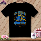 A black crewneck t-shirt featuring a blue and yellow Los Angeles Quilter graphic with a spool of thread and needle.