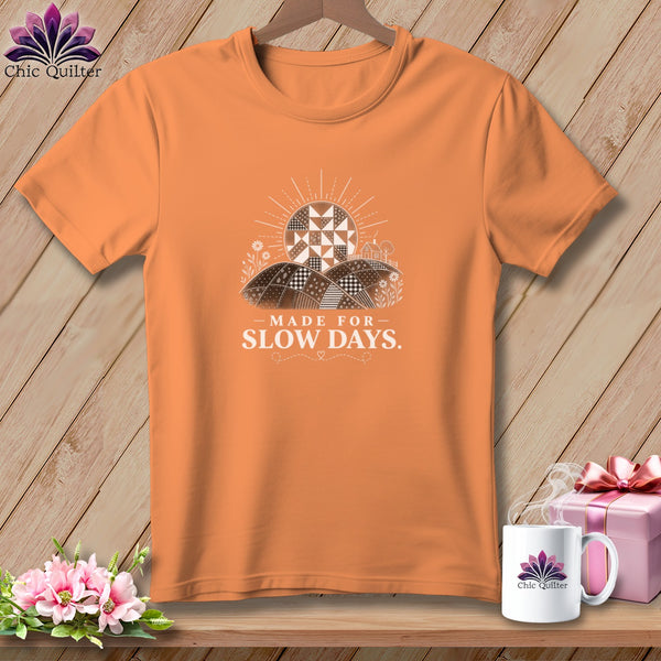 Orange t-shirt with "Made for Slow Days" text and a sunburst quilt design.