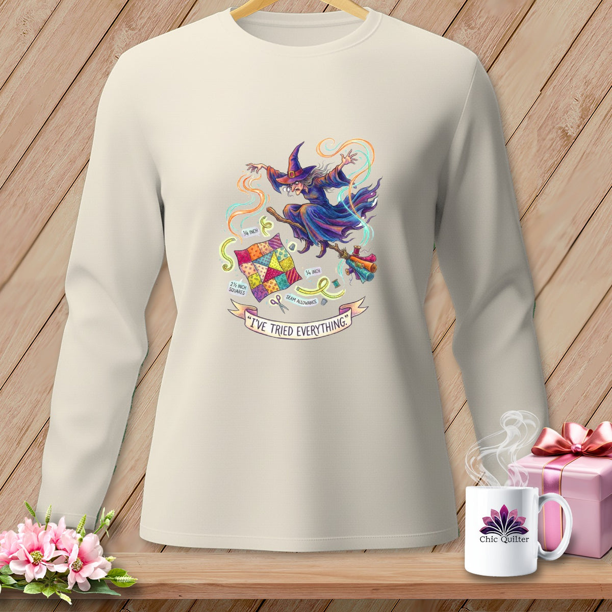 Long-sleeve shirt with a witch on a broomstick, surrounded by quilting elements and text.