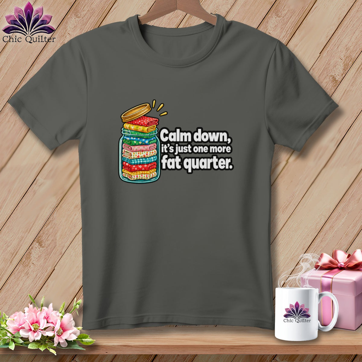 Dark gray t-shirt featuring a mason jar filled with fabric stacks and the text, Calm down, it's just one more fat quarter.