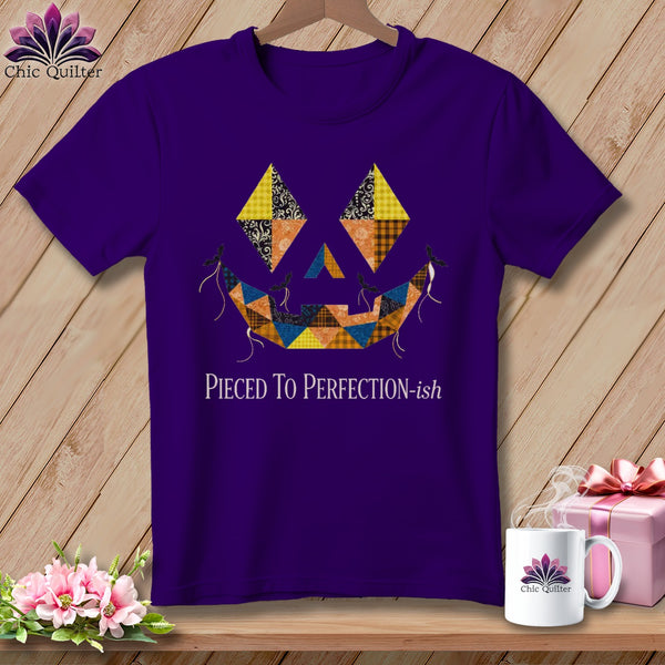 Purple t-shirt with a patchwork jack-o'-lantern face and text "Pieced To Perfection-ish".
