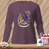 Long-sleeve purple shirt with a witch sewing a quilt, text reads 