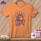 An orange t-shirt displays a graphic of a colorful, feathered bird nestled inside a basket of fabric scraps.