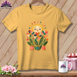 Yellow t-shirt hanging on a wooden wall, featuring a whimsical graphic of a smiling sun and colorful quilted flower pots.