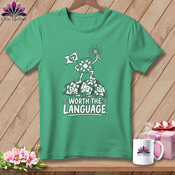 Green t-shirt with cartoon quilting blocks, text "WORTH THE LANGUAGE"