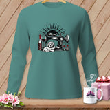 Teal long sleeve shirt with a sewing machine, dog, wine, and yarn graphic.