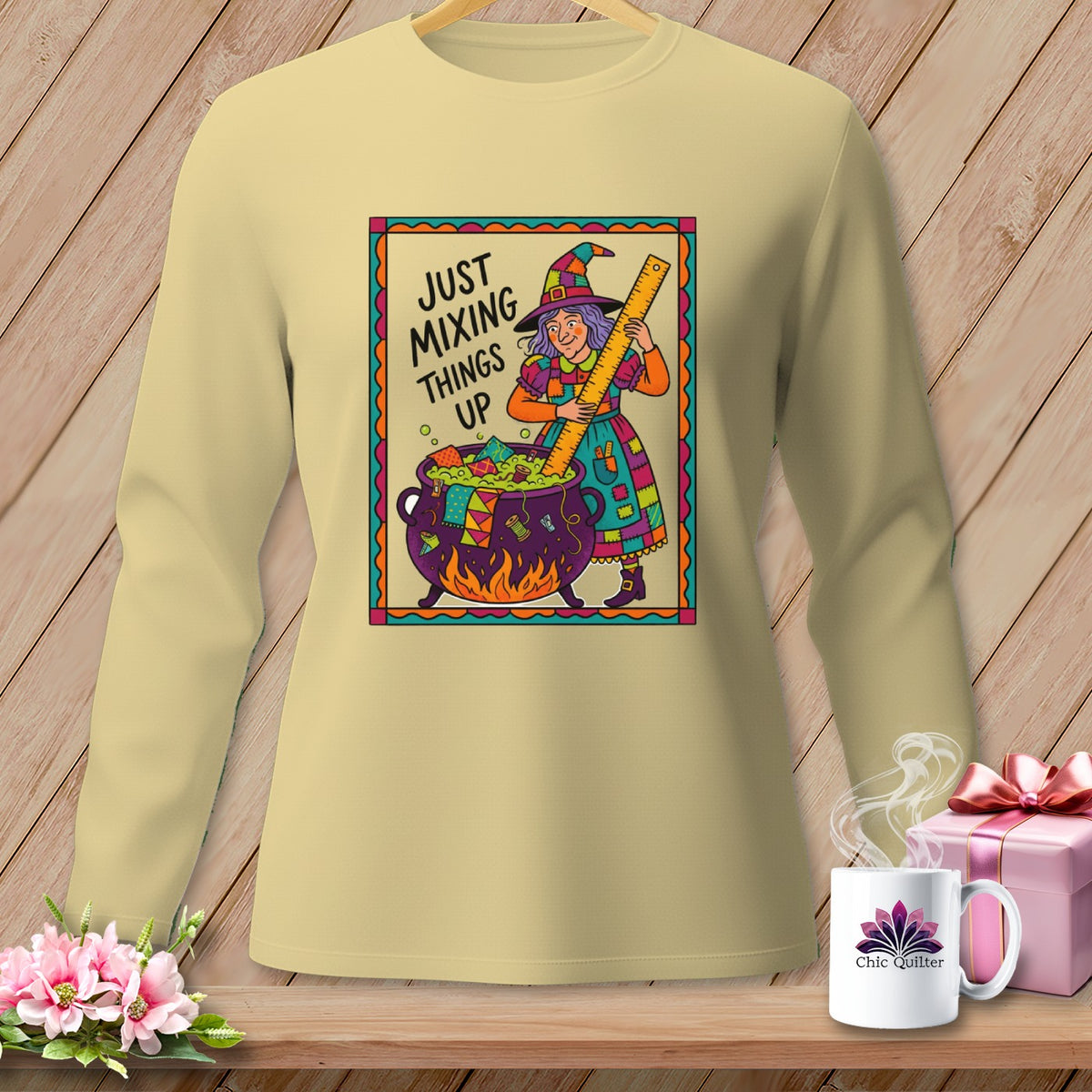 Light yellow long-sleeve shirt with "Just Mixing Things Up" and a witch mixing cauldron graphic.