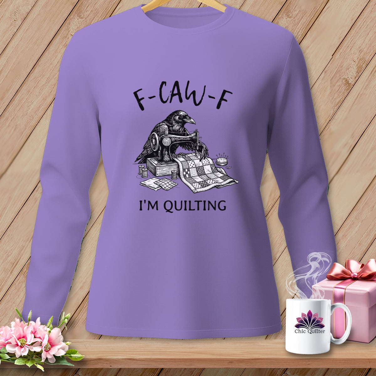 Long-sleeve purple shirt with raven sewing a quilt, reads "F-CAW-F I'M QUILTING".