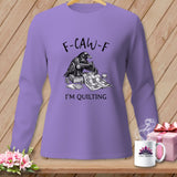 Long-sleeve purple shirt with raven sewing a quilt, reads 
