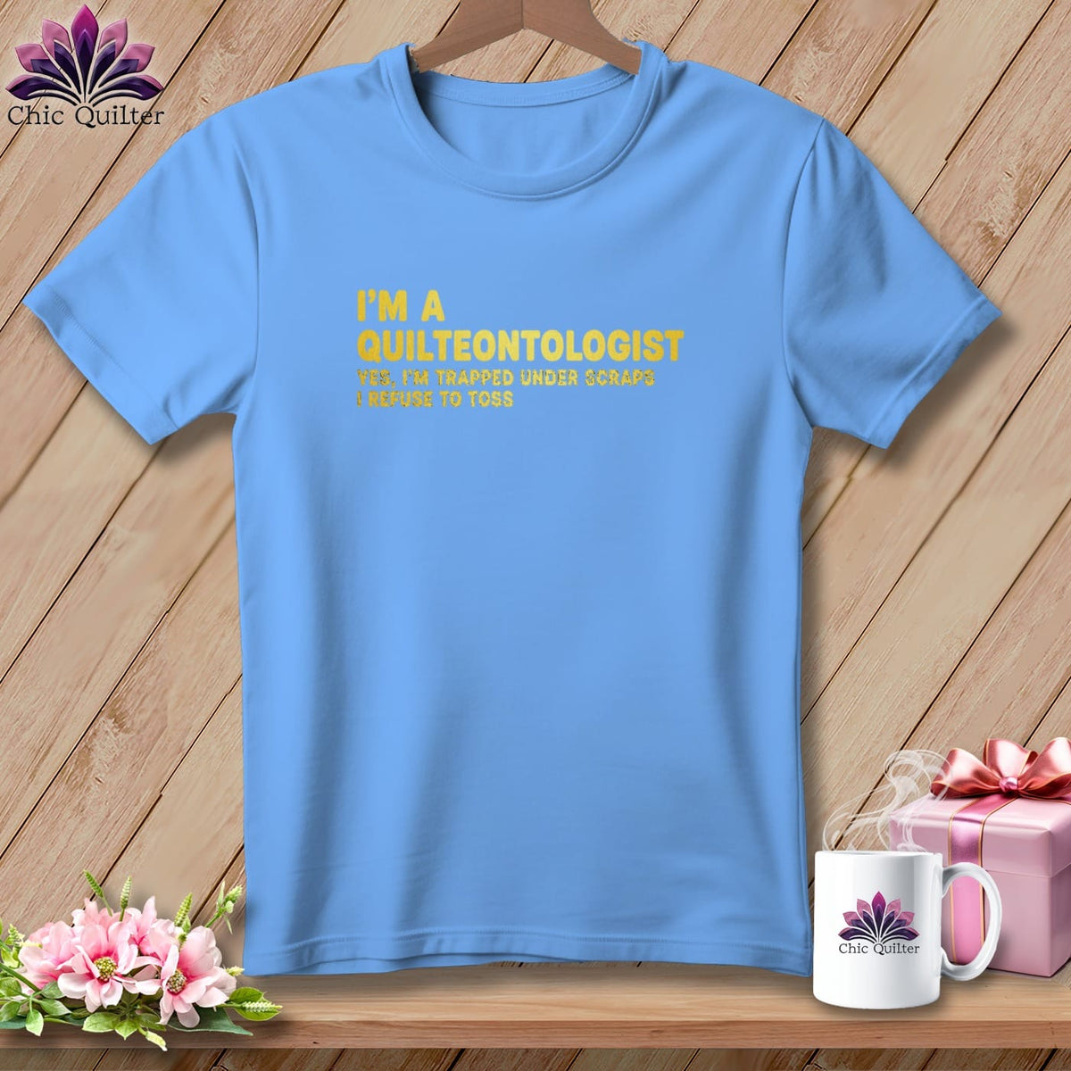 Light blue t-shirt with yellow text: "I'M A QUILTEONTOLOGIST YES, I'M TRAPPED UNDER SCRAPS I REFUSE TO TOSS."