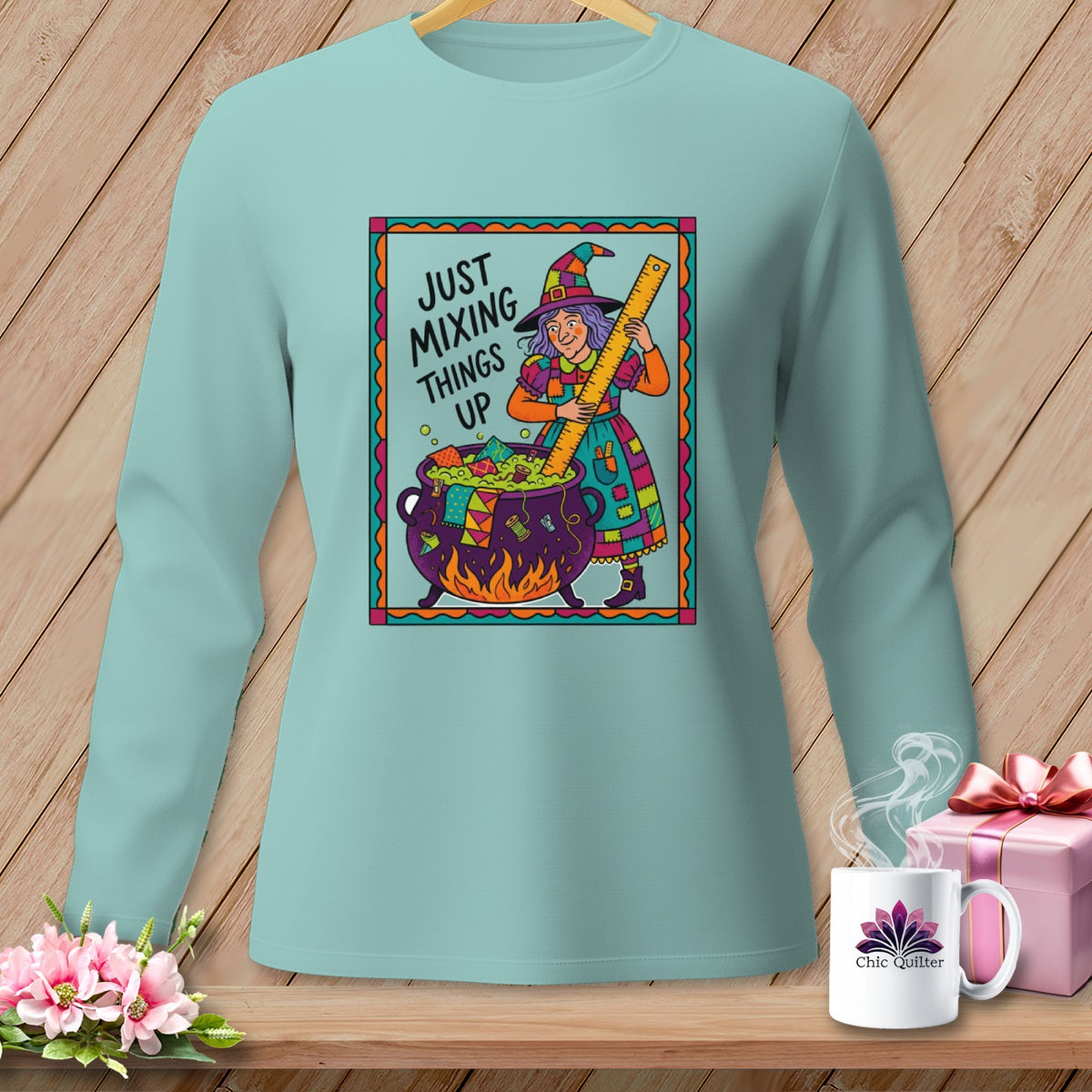Light blue long sleeve shirt with "Just Mixing Things Up" text and a witch illustration.