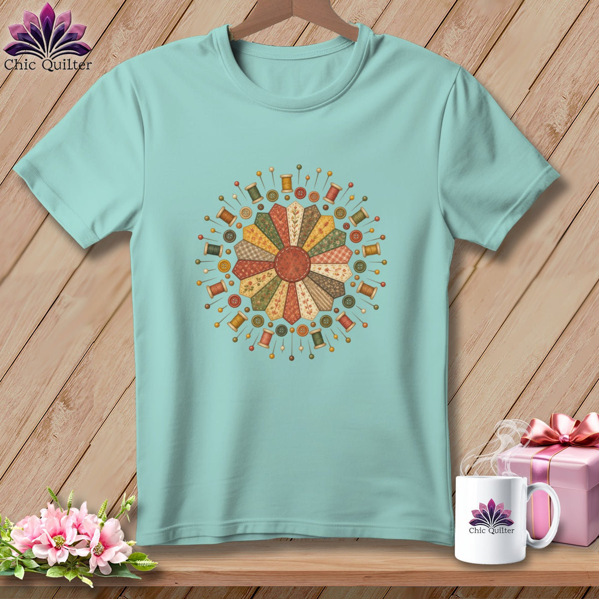 Teal t-shirt with a circular patchwork design of sewing notions.