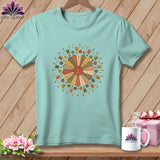 Teal t-shirt with a circular patchwork design of sewing notions.