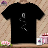 Black t-shirt with white embroidery design of thread, needle, and spool of thread.