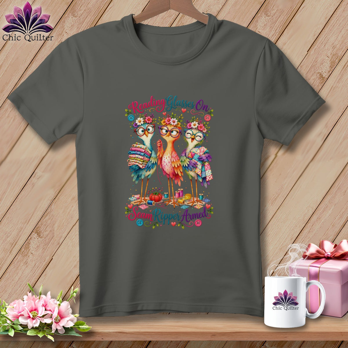 Dark gray t-shirt with a cartoon graphic of three colorful birds wearing glasses and flower crowns.