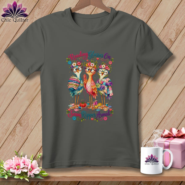 Dark gray t-shirt with a cartoon graphic of three colorful birds wearing glasses and flower crowns.