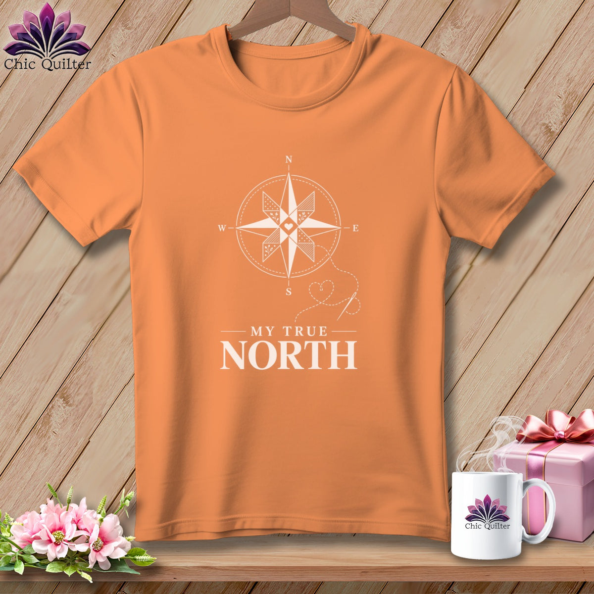 Orange t-shirt with white compass design and text "MY TRUE NORTH".
