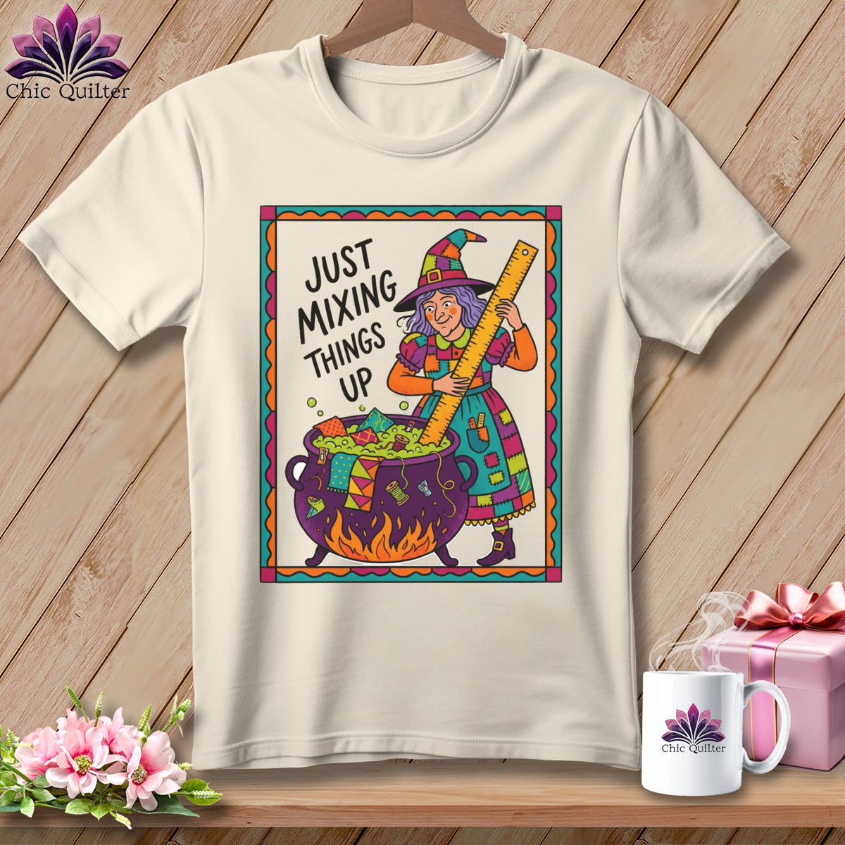 T-shirt with cartoon witch stirring cauldron with ruler, text "JUST MIXING THINGS UP".
