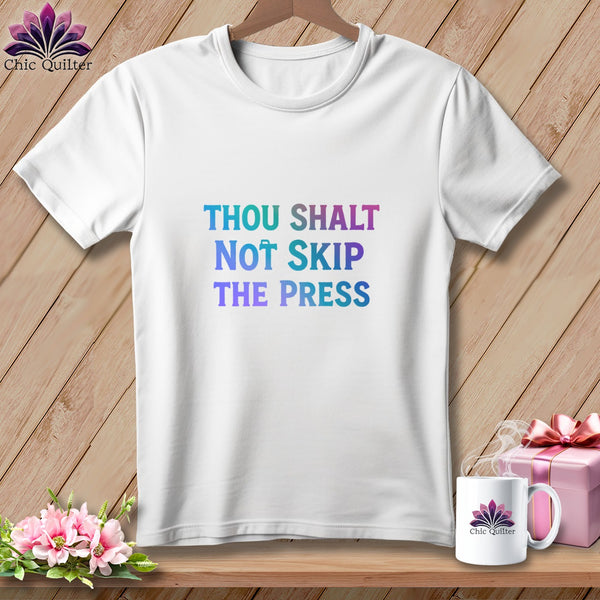 White t-shirt with "THOU SHALT NOT SKIP THE PRESS" text in gradient colors.