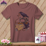 T-shirt graphic of ravens, sewing machine, measuring tape, scissors, and text 