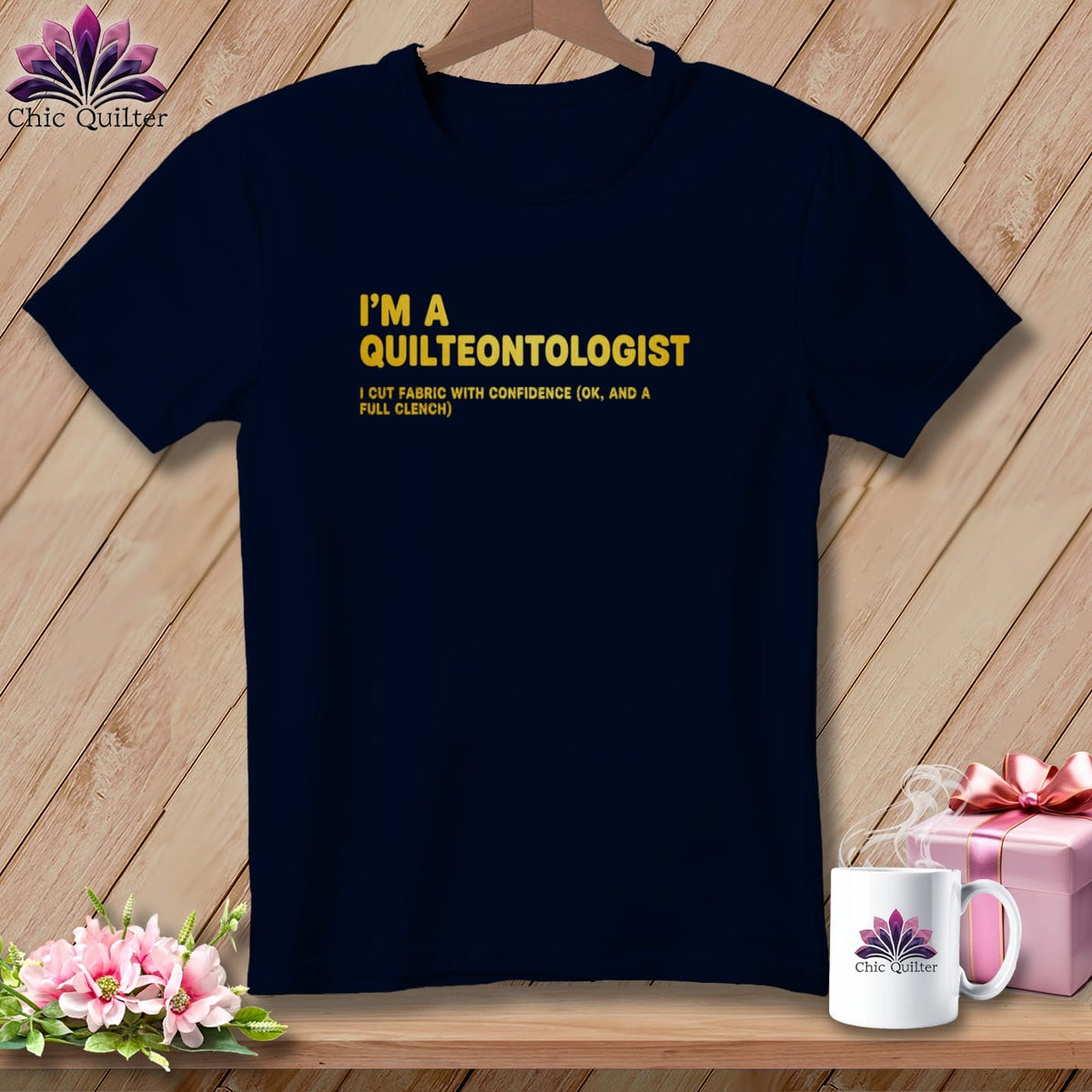 Navy t-shirt with yellow text reading "I'M A QUILTEONTOLOGIST" and "I CUT FABRIC WITH CONFIDENCE".