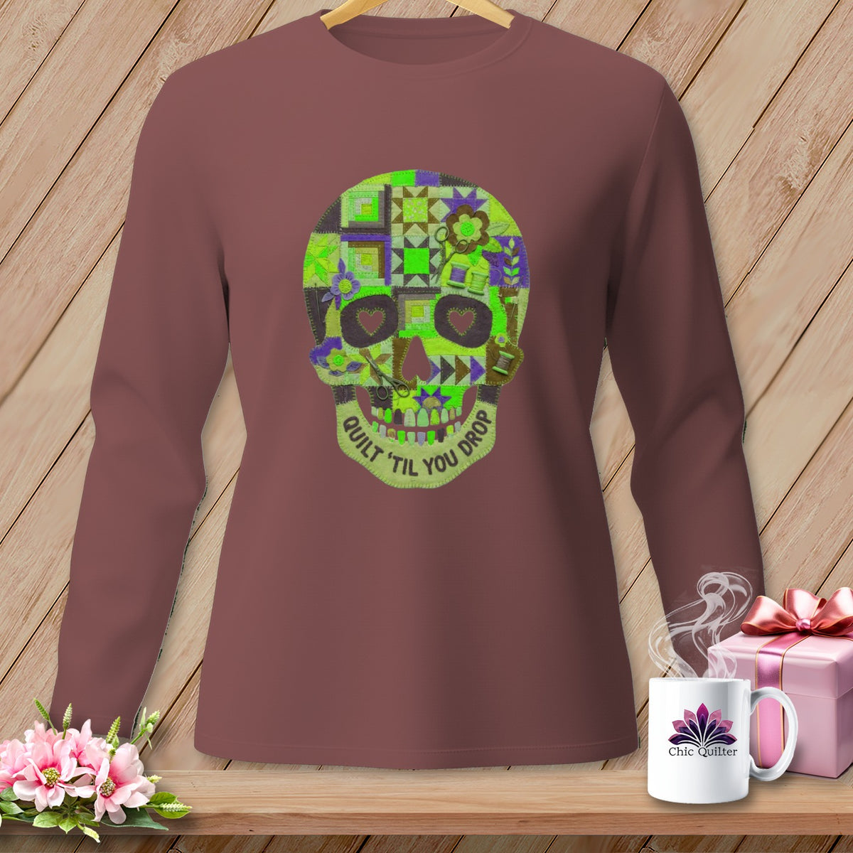Brown long-sleeve shirt with a quilted skull graphic that says "QUILT 'TIL YOU DROP".