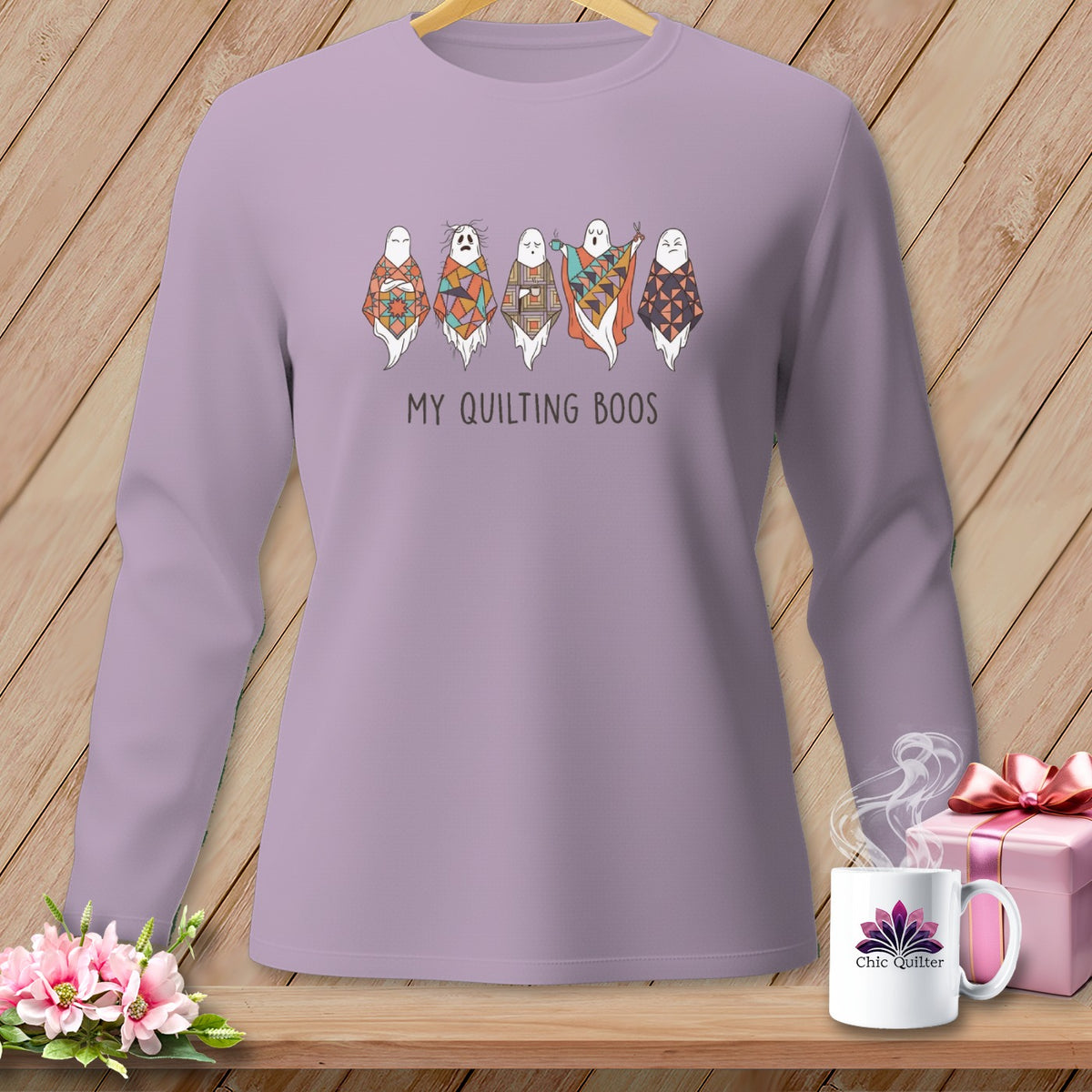 Lavender long-sleeve shirt with "My Quilting Boos" text and quilted ghost graphics.