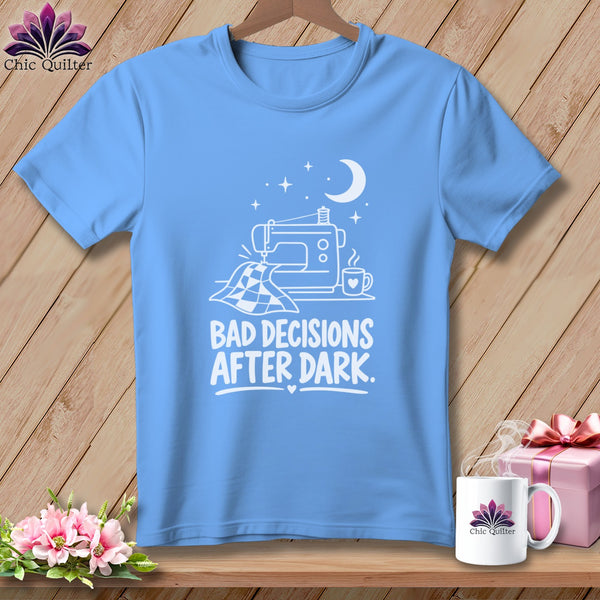 Light blue t-shirt with white graphic of sewing machine, quilt, mug, moon, and stars, with text "BAD DECISIONS AFTER DARK."