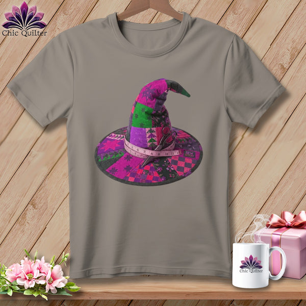 Gray t-shirt featuring a patchwork witch hat with scissors and measuring tape.