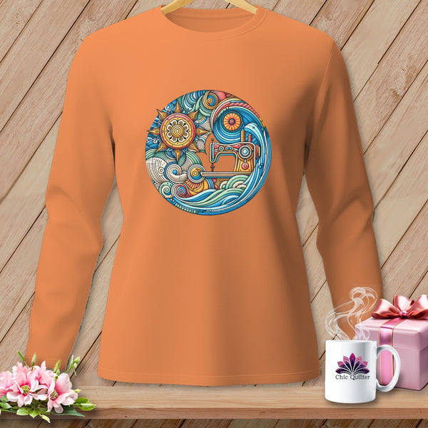 Orange long-sleeve shirt with a circular sewing machine, sun, and wave graphic.