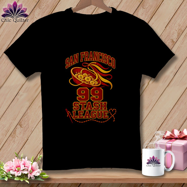 Black t-shirt featuring San Francisco 99 Stash League text with a sewing graphic of buttons and ribbons.