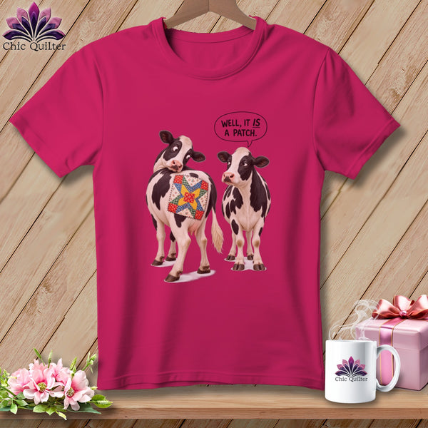 Two cows on a pink t-shirt, one with a quilt patch, saying "Well, it is a patch."