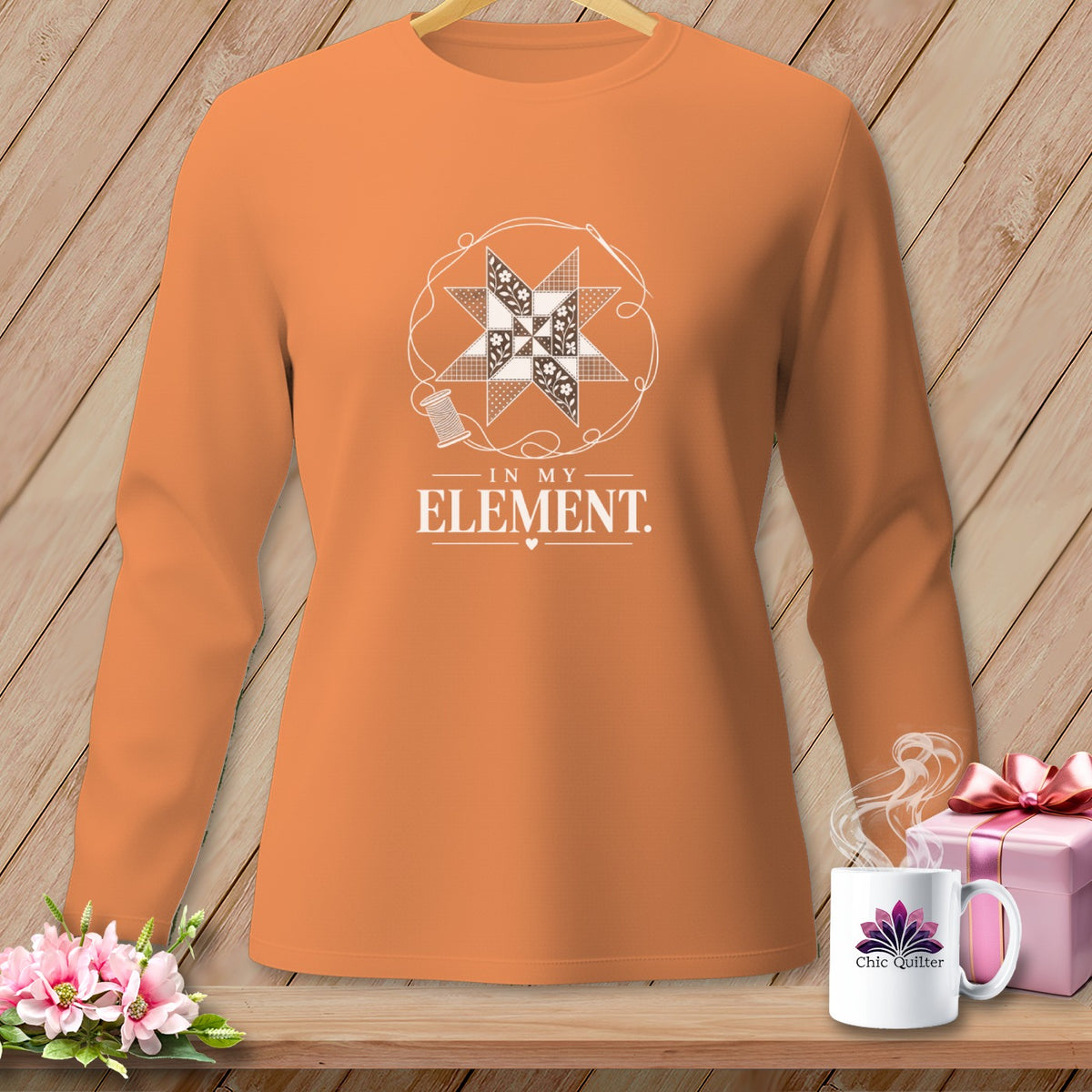 Orange long-sleeve shirt with a quilt star graphic and text "IN MY ELEMENT".