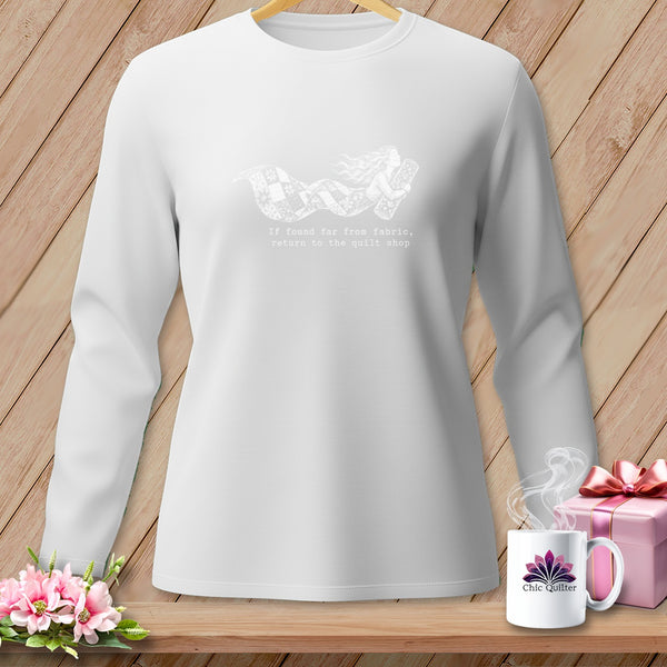 White long-sleeve shirt with a design of a woman holding fabric and text.