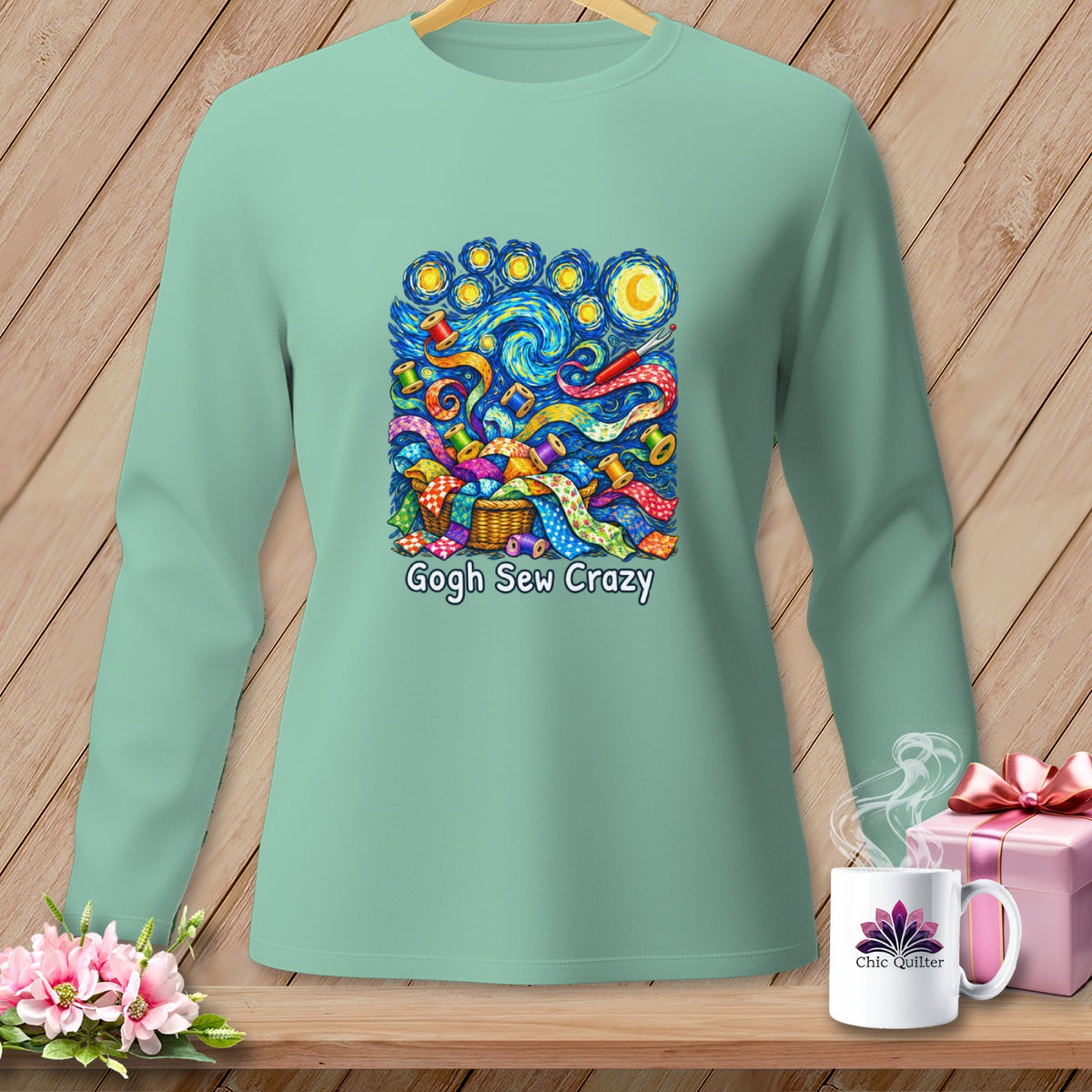 Mint green long sleeve shirt with "Gogh Sew Crazy" graphic of fabric scraps and spools.