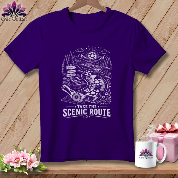 Purple t-shirt with graphic of a winding quilt road and text "TAKE THE SCENIC ROUTE".