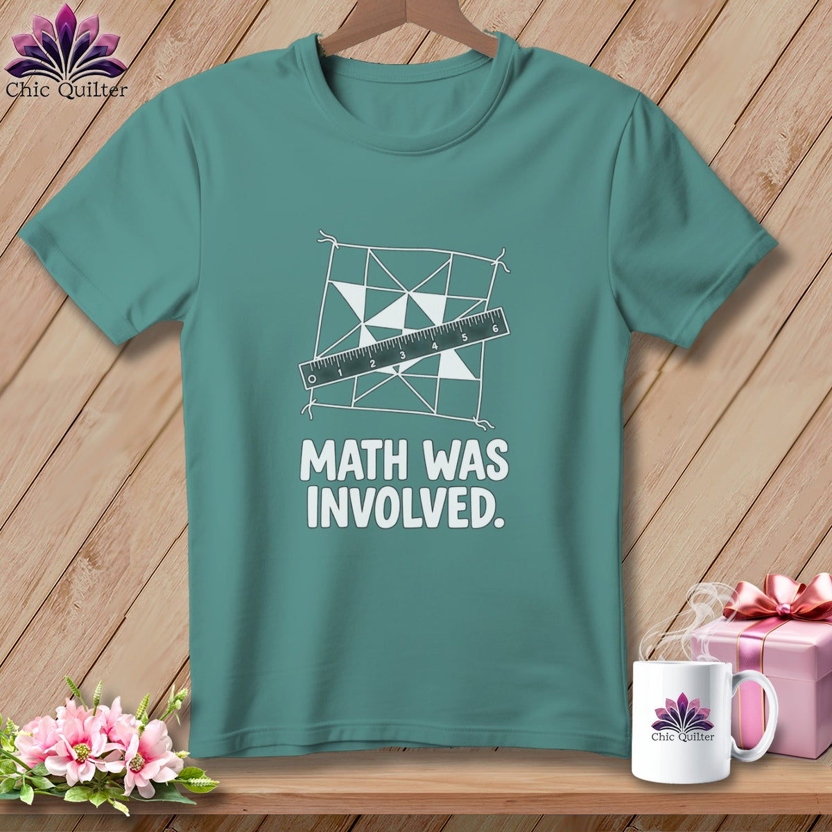 Teal t-shirt with quilting design, ruler, and text "MATH WAS INVOLVED."