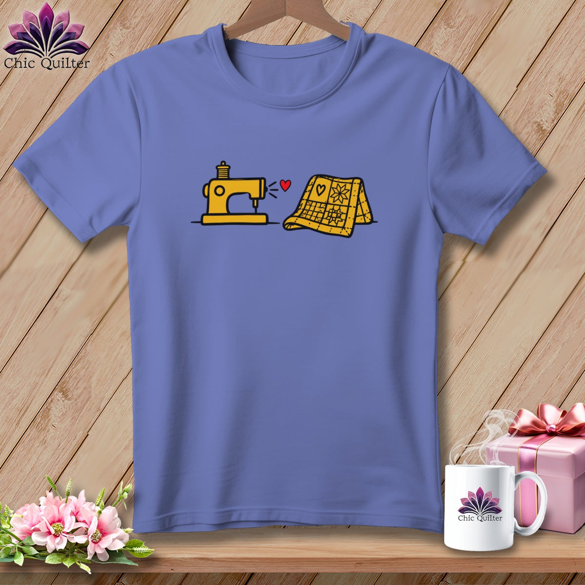 Purple t-shirt featuring a yellow sewing machine and quilt graphic hanging on a wooden wall.