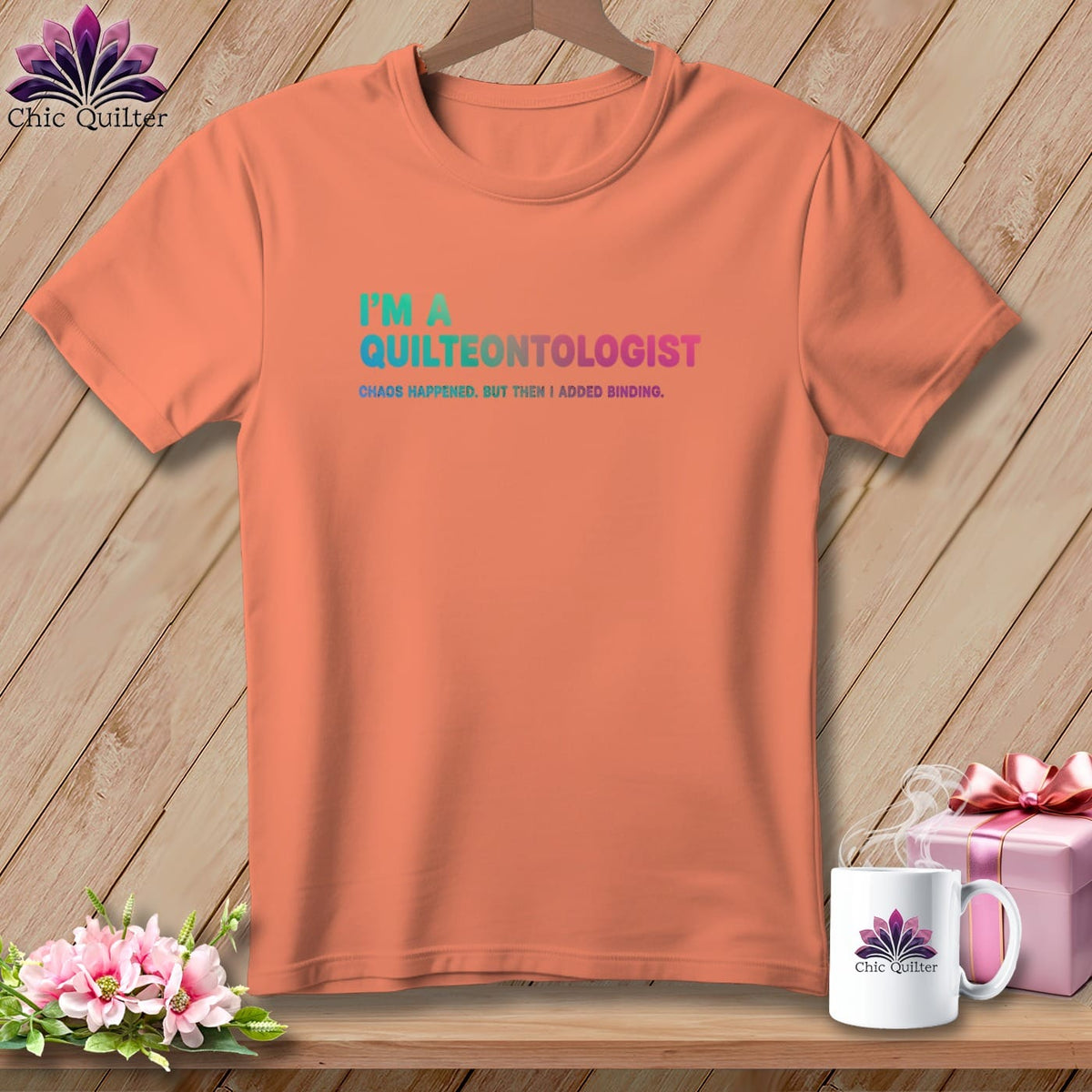 Peach t-shirt with "I'M A QUILTEONTOLOGIST" and "CHAOS HAPPENED. BUT THEN I ADDED BINDING."