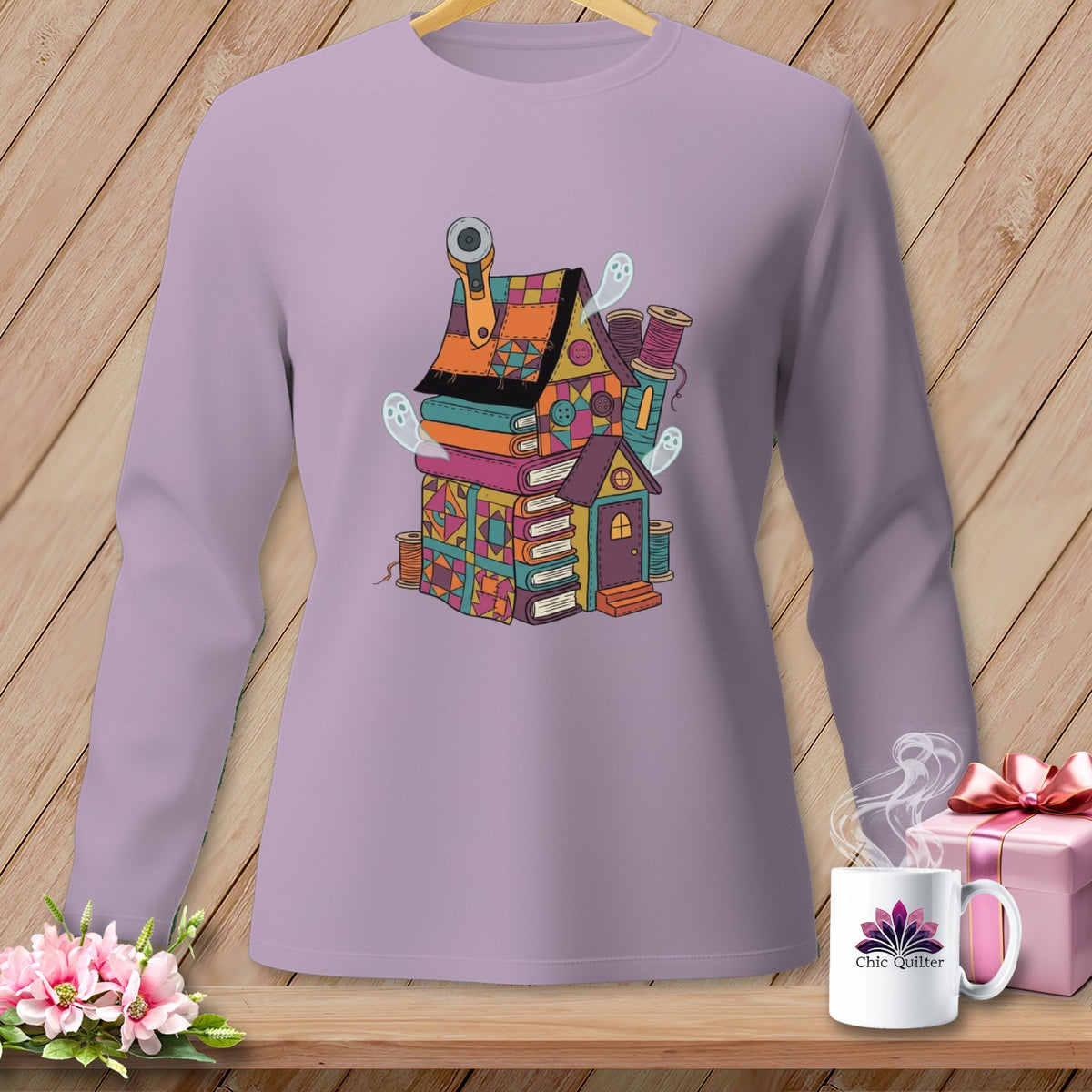Long-sleeve purple shirt with a whimsical illustration of a house made of books and fabric scraps.