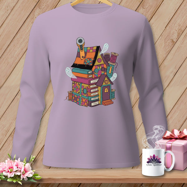 Long-sleeve purple shirt with a whimsical illustration of a house made of books and fabric scraps.