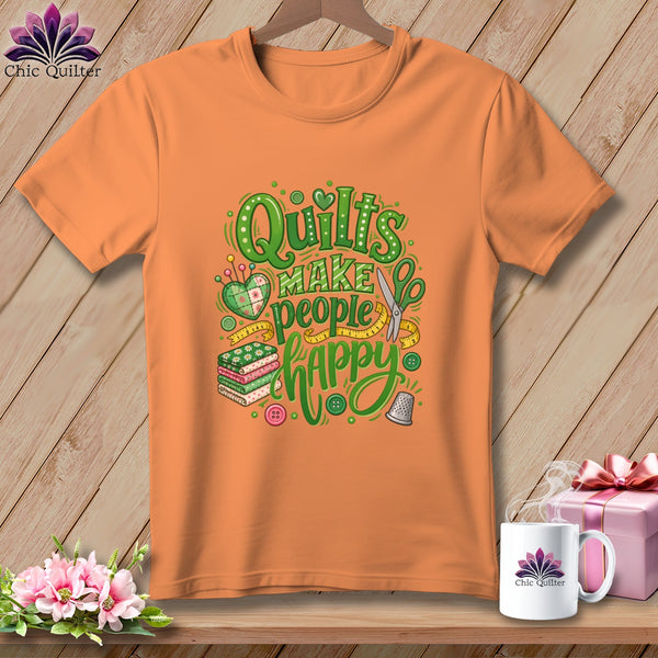 Orange crewneck t-shirt featuring green graphic text that reads Quilts Make People Happy.