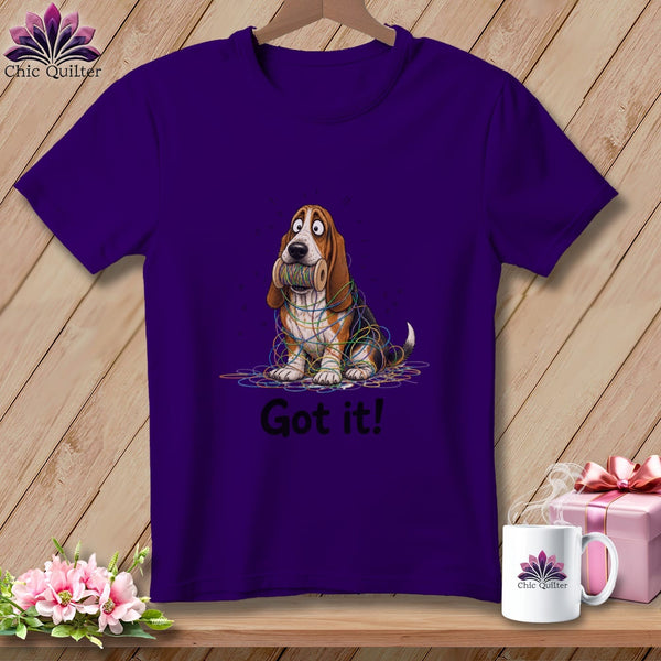 Purple t-shirt with cartoon basset hound tangled in colorful yarn, "Got it!" text.