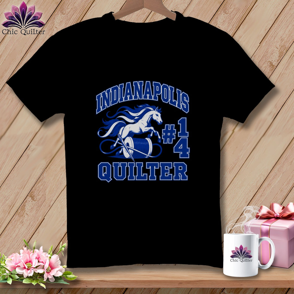 Black t-shirt featuring blue text reading Indianapolis Quilter with a white horse and thread spool graphic.