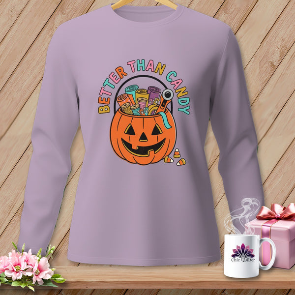 Purple long sleeve shirt with jack-o'-lantern filled with spools of thread and text "Better Than Candy".