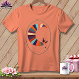 Orange t-shirt with a patchwork crescent moon and witch design inside an embroidery hoop.