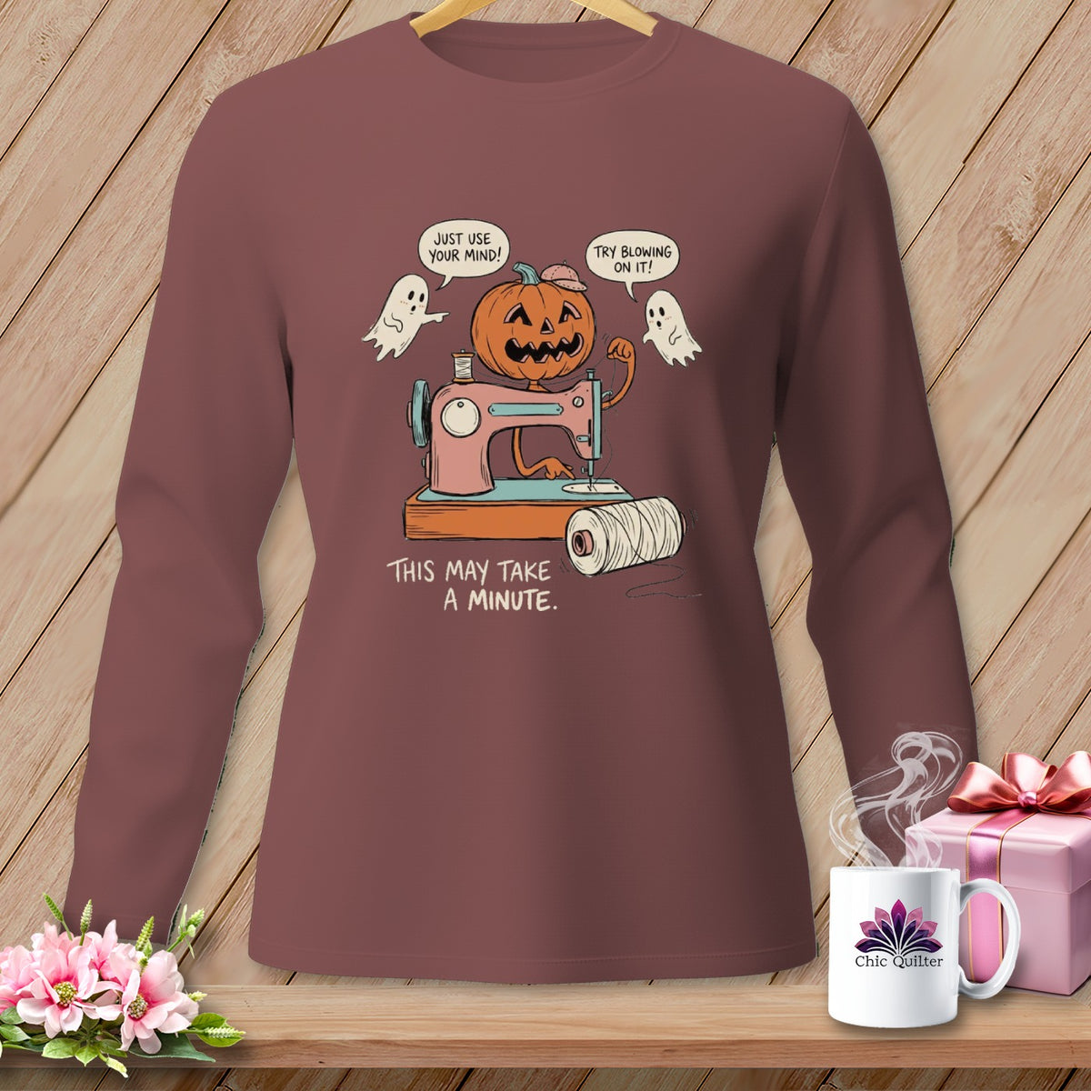 Halloween pumpkin using a sewing machine, with ghosts saying "Just use your mind!" and "Try blowing on it!".
