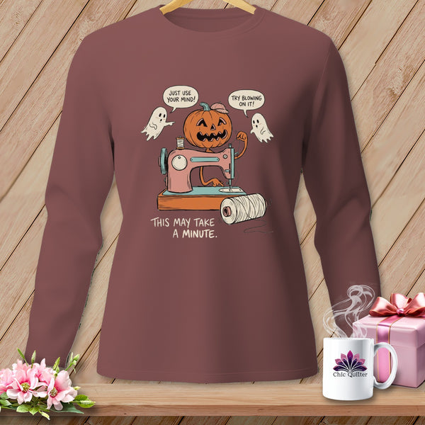 Halloween pumpkin using a sewing machine, with ghosts saying "Just use your mind!" and "Try blowing on it!".