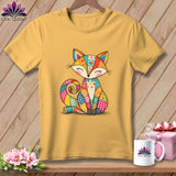 Mustard yellow t-shirt featuring a colorful patchwork fox graphic hanging on a wooden background.